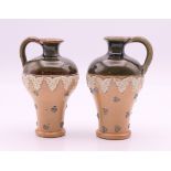 A pair of Doulton stoneware miniature jugs. Tallest 7.5 cm high.