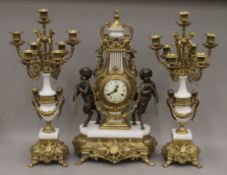 A gilt metal mounted clock garniture. The clock 62 cm high.