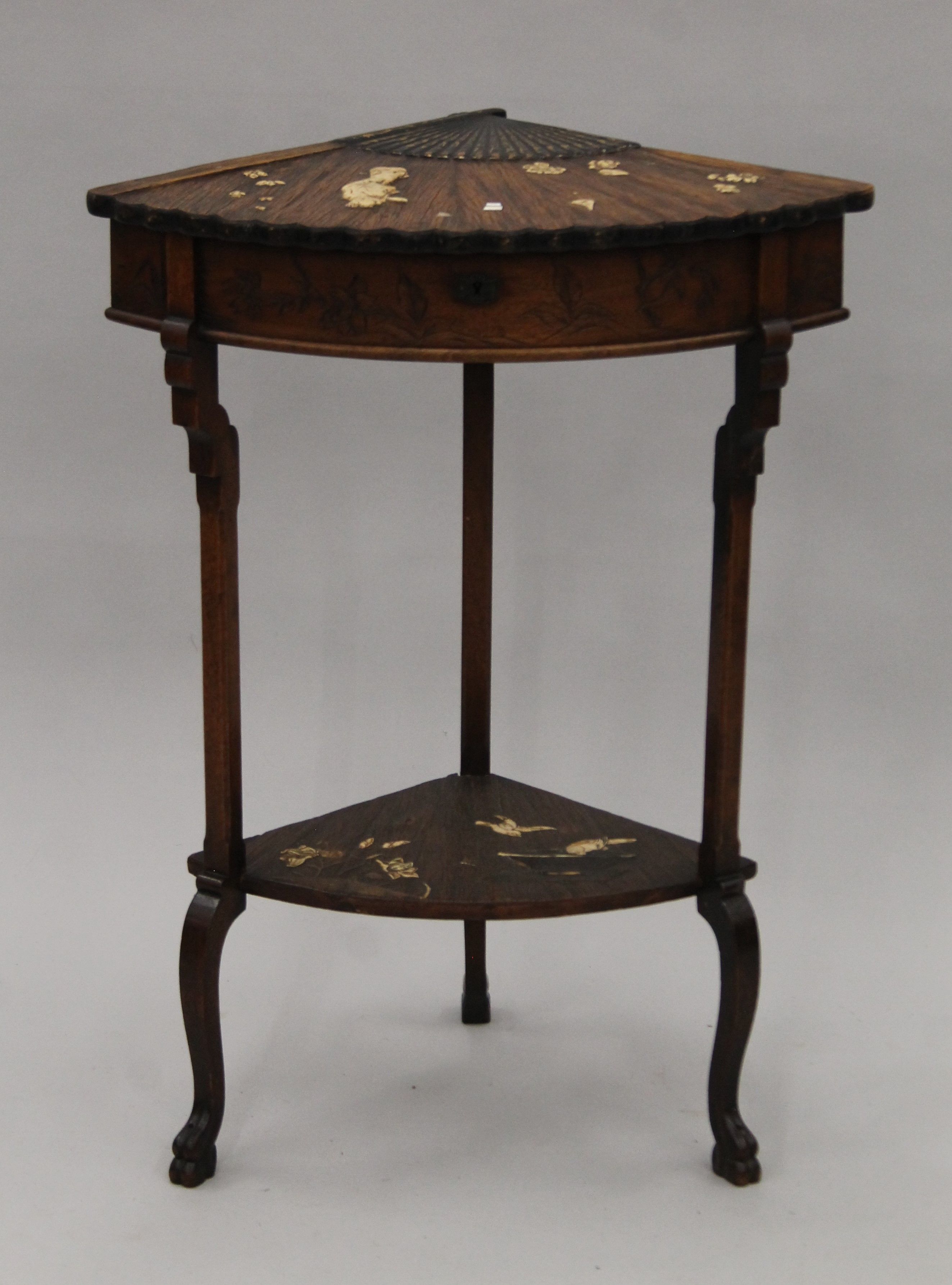 A aesthetic period walnut side table decorated in the Japanese manner, with lift up fan shaped lid.