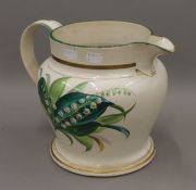 A large 19th century florally painted porcelain jug. 23.5 cm high.