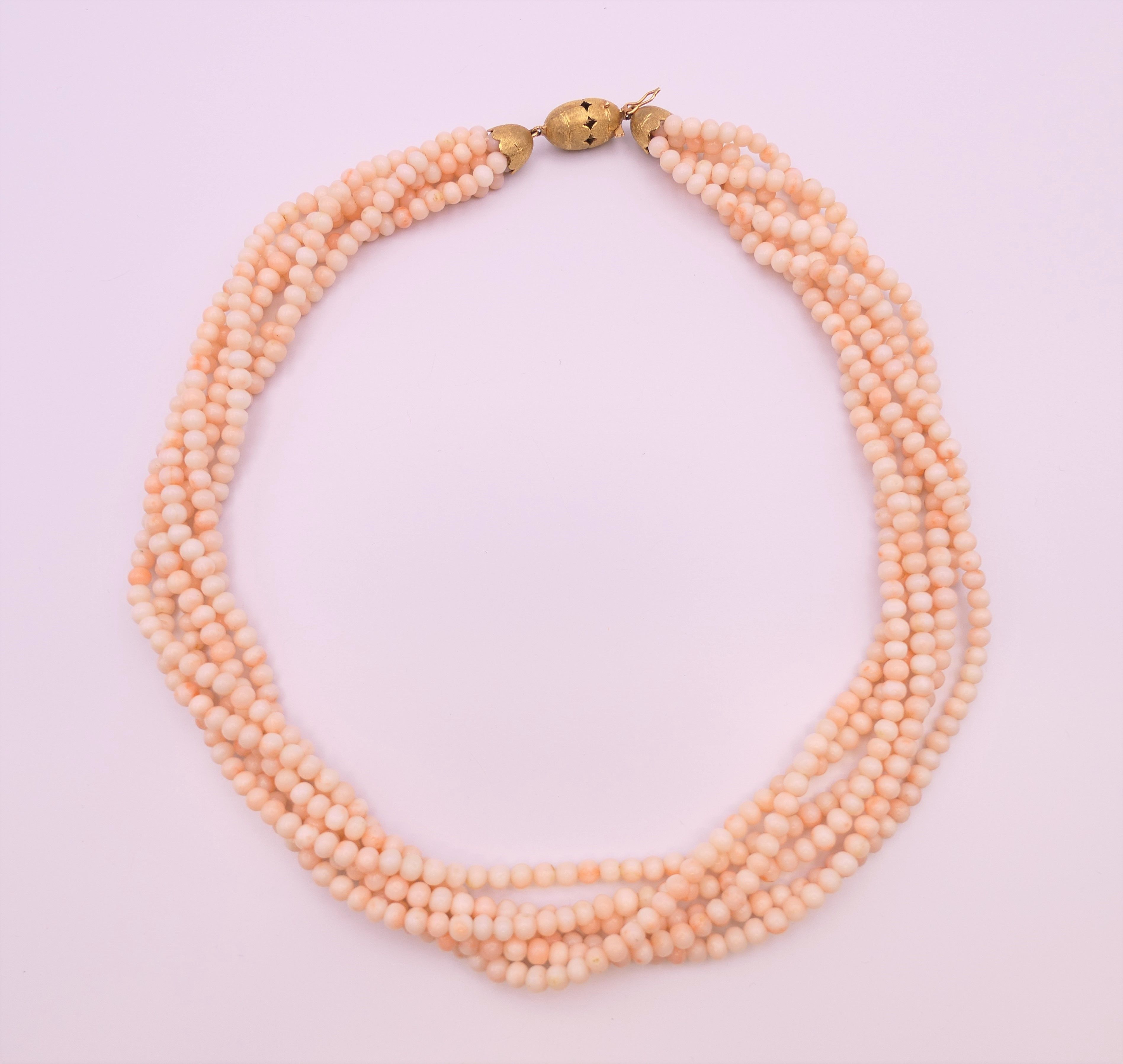 A six strand pearl necklace with an 18 ct gold clasp. 50 cm long.