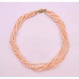 A six strand pearl necklace with an 18 ct gold clasp. 50 cm long.