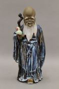 A flambe glazed figure of god of long life. 28 cm high.