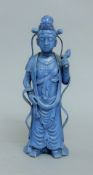 A Chinese blue porcelain figure. 24 cm high.