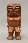 A Japanese carved wooden figure. 32 cm high.