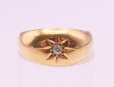 An 18 ct gold diamond gypsy set solitaire ring. Ring size J/K. 2.6 grammes total weight.