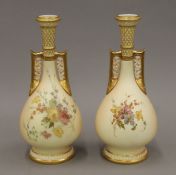 A pair of Royal Worcester florally painted blush ivory porcelain vases. 25 cm high.