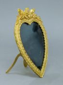 A gilt bronze heart shaped photograph frame. 18.5 cm high.