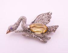 A citrine and diamond gold backed swan brooch. 4 cm wide.