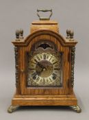 A small oak mantle clock. 23 cm high.