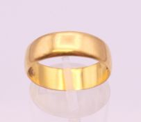 A 22 ct gold wedding band. Ring size P. 4.5 grammes.