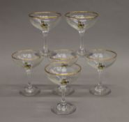 A quantity of Babycham glasses.