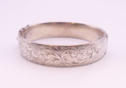 A silver bangle form bracelet. 6.5 cm internal diameter. 36 grammes.