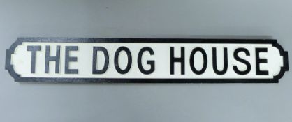 A wooden Dog House sign.