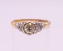 An 18 ct gold and platinum diamond solitaire ring. Ring size N/O. 3.3 grammes total weight.