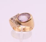 A 9 ct gold amethyst and diamond ring. Ring size I/J. 8.1 grammes total weight.