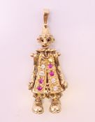 A 9 ct gold gemstone (cubic zirconia) set articulated circus clown pendant.