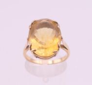 An unmarked gold citrine ring. Ring size O/P. 5.7 grammes total weight.