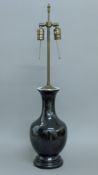 A Chinese black porcelain lamp. 81 cm high overall.