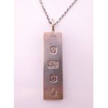 A silver ingot on a silver chain. The ingot 4.5 cm high. 21.3 grammes.