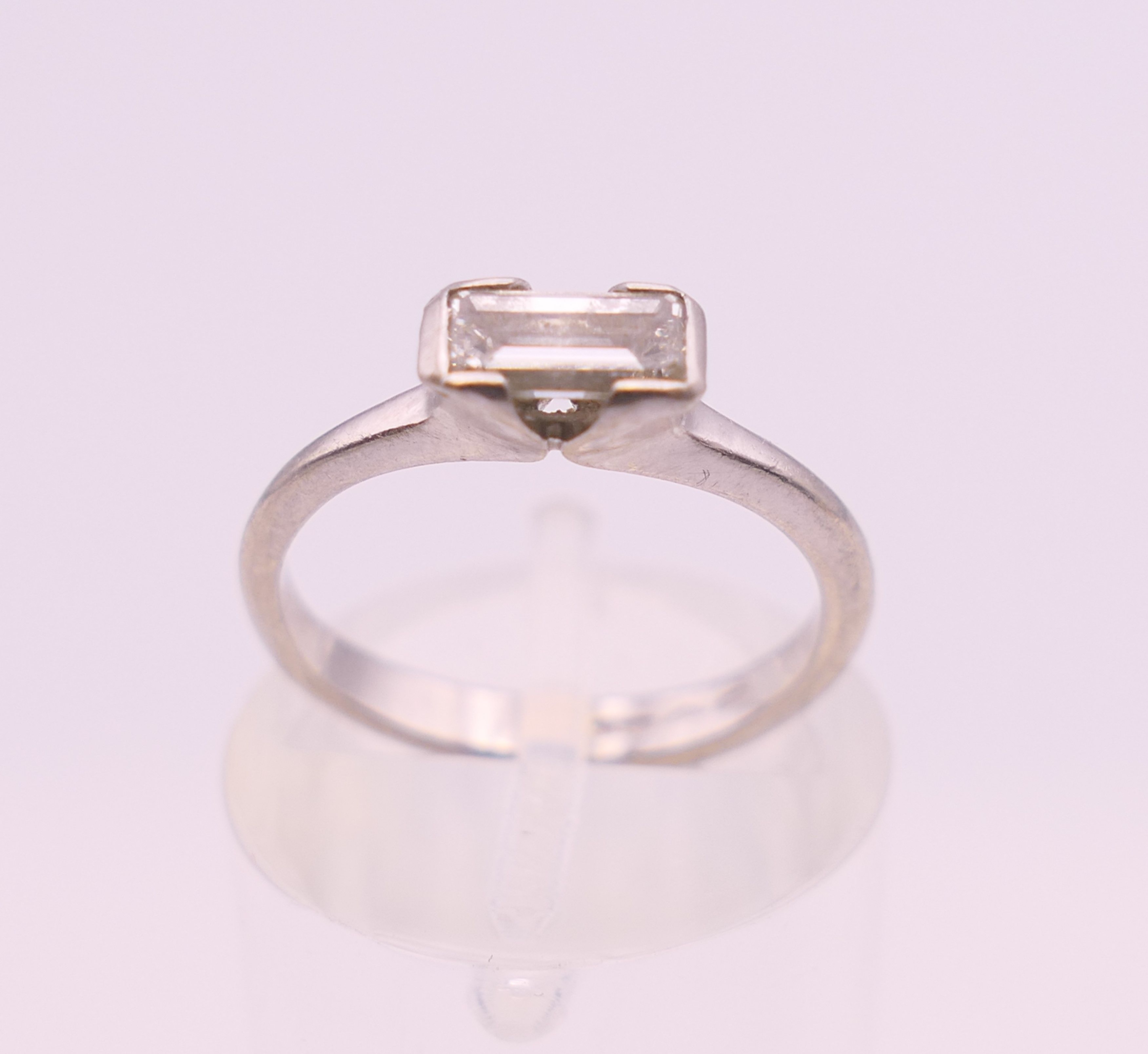 A platinum diamond solitaire ring. Ring size G/H. 3.3 grammes total weight.