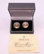 A pair of Rolex cufflinks. 1.75 cm diameter.