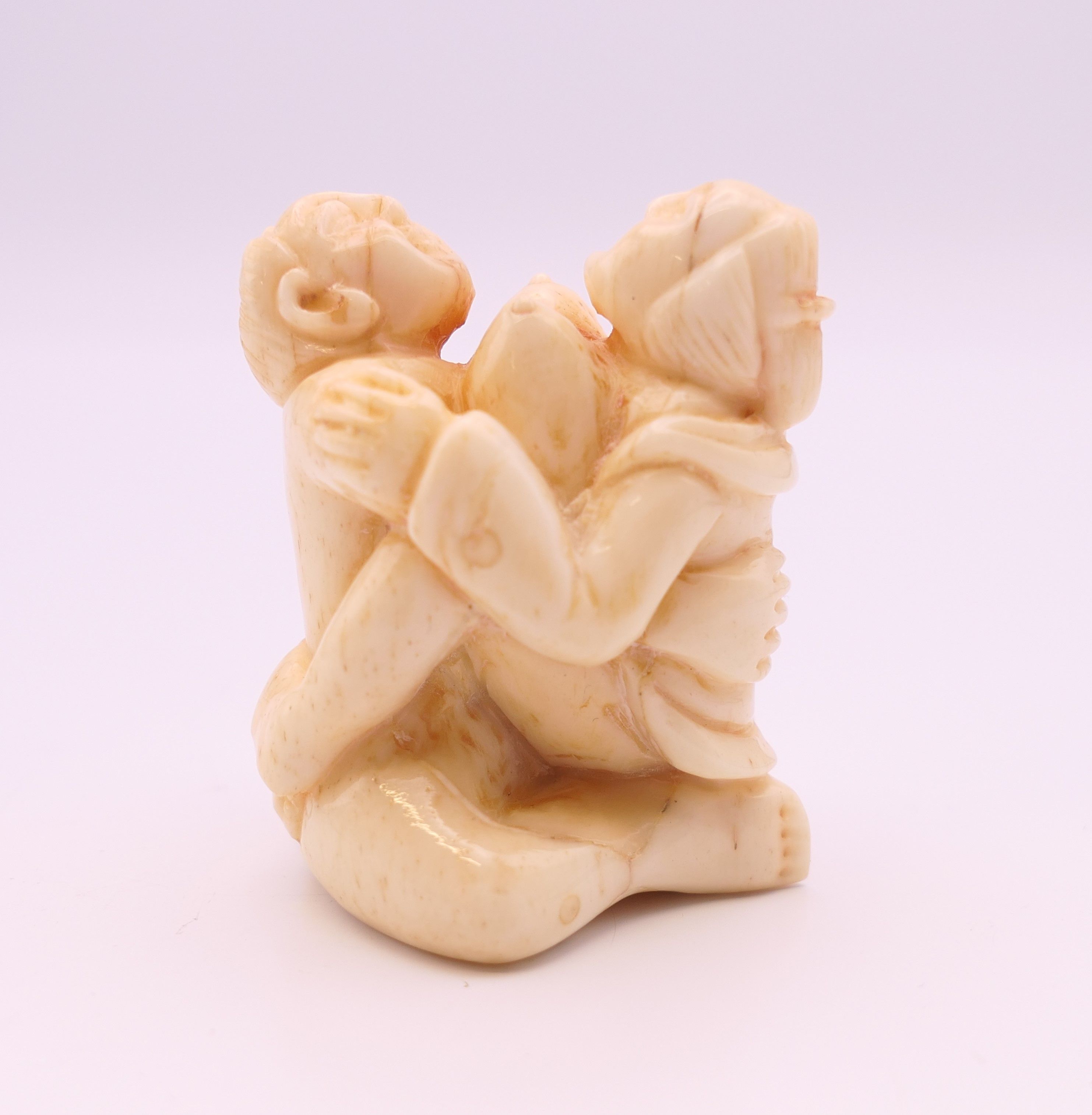 An erotic bone carving. 4 cm high.