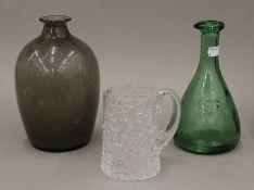 Three pieces of glassware; a vase, a tankard and a bottle. The former 23 cm high.