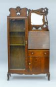 An early 20th century carved oak hall bureau with glazed cabinet. 94 cm wide.