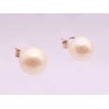 A pair of 9 ct gold pearl earrings. 7 mm high.