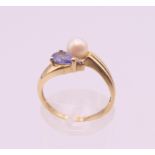 A 9 ct gold tanzanite, pearl and diamond ring. Ring size M. 2.4 grammes total weight.