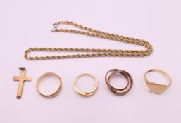 A quantity of 9 ct gold rings, a 9 ct gold chain and a 9 ct gold cross.