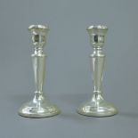 A pair of silver candlesticks. 15 cm high.