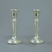 A pair of silver candlesticks. 15 cm high.