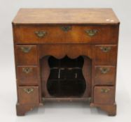 An 18th century walnut veneered kneehole desk. 79.5 cm wide.