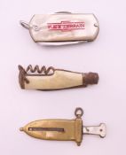 A cigar cutter formed as a dagger and two penknives.