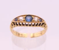 An 18 ct gold diamond and sapphire navette ring. Ring size O/P. 3.2 grammes total weight.