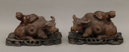 A pair of Chinese carvings formed as a boy on a buffaloes back,