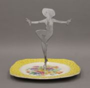 An Art Deco sandwich plate with figural handle. 20 cm high.