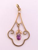 An unmarked gold Art Nouveau amethyst and seed pearl pendant. 3.5 cm high. 1.4 grammes total weight.