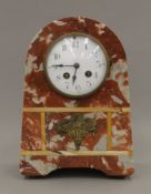 A French Art Deco marble mantle clock with brass appliques. 30 cm high.