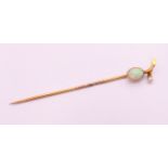 An unmarked 9 ct gold opal and pearl stick pin. 6 cm long. 1.2 grammes total weight.