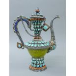 A Tibetan unmarked silver, turquoise and coral teapot. 30 cm high.