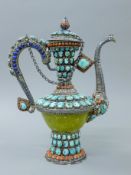 A Tibetan unmarked silver, turquoise and coral teapot. 30 cm high.