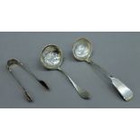 A silver sifter spoon, a pair of silver tongs and a silver sauce ladle. 87.1 grammes.