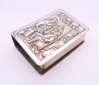 A Continental silver matchbox holder, the front decorated with a tavern scene. 5.5 x 4 x 1.75 cm.