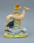 A 19th century Staffordshire pottery spill figure of two coursing greyhounds, Apollo and Daphne,