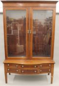 A 19th century cross banded and line inlaid mahogany display cabinet. 221 cm high x 144 cm wide.