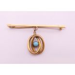 A 15 ct gold pin with plated turquoise set pendant. 5 cm long, pendant 2 cm high. 5.