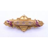 A 9 ct gold ruby and diamond brooch. 4.5 cm long. 5.4 grammes total weight.